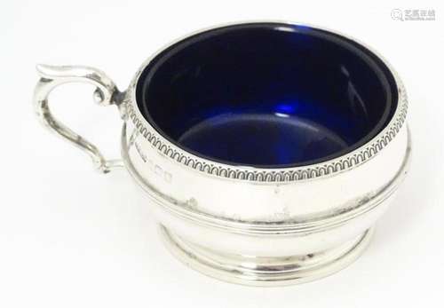 A silver salt with blue glass liner hallmarked Bir…