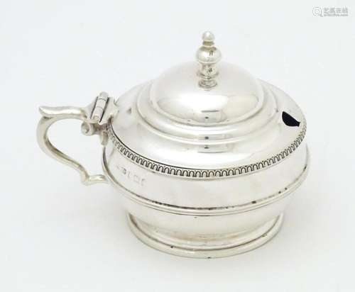 A silver mustard pot with blue glass liner hallmar…