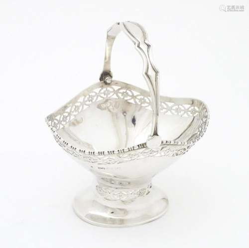 A silver sugar basket with swing handle, hallmarke…