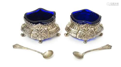 A pair of silver salts with blue glass liners with…