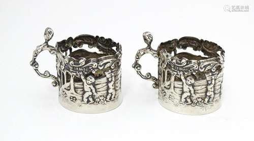 A pair of miniature silver cup sleeves / tot glass…