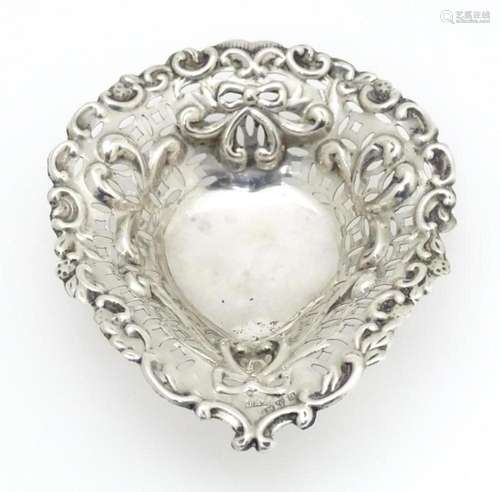 A silver bonbon dish of stylised heart form with p…