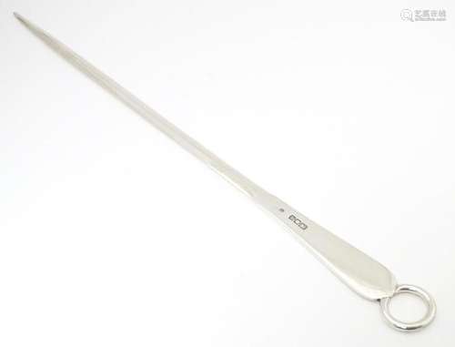 A large silver meat skewer, hallmarked London 1916…