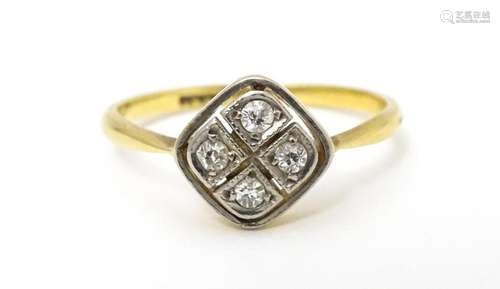 An 18ct gold ring set with four diamonds in an Art…