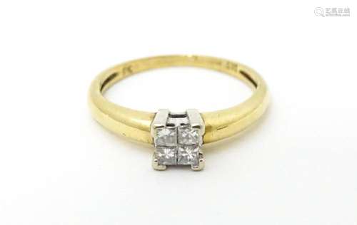 A 9ct gold ring set with four diamonds in a square…