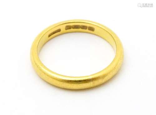 A 22ct gold ring. Ring size approx. M …