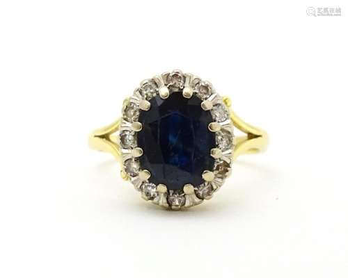 An 18ct gold ring set with central sapphire border…