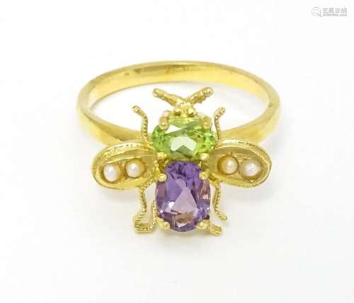 A silver gilt ring with bee / winged insect decora…