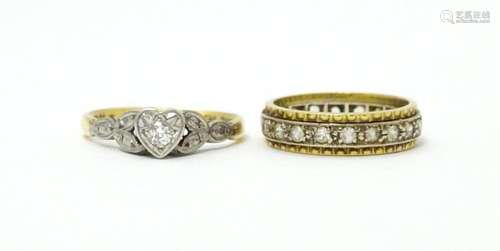 An 18ct gold ring with platinum set central diamon…