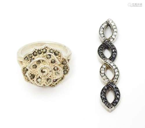 A silver ring set with marcasite detail. Together …