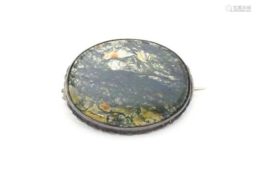 A white metal brooch set with central moss agate c…