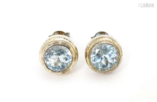 A pair of white metal stud earrings set with centr…