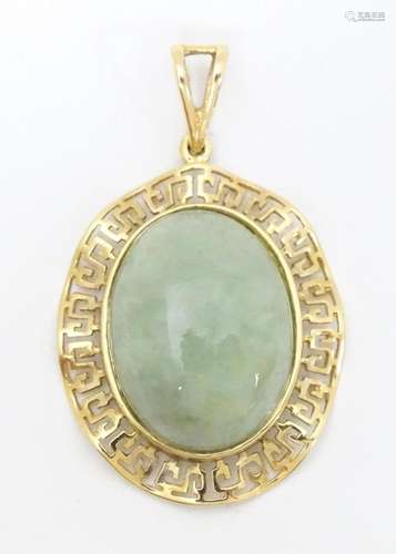 A 9ct gold pendant set with jade coloured cabochon…