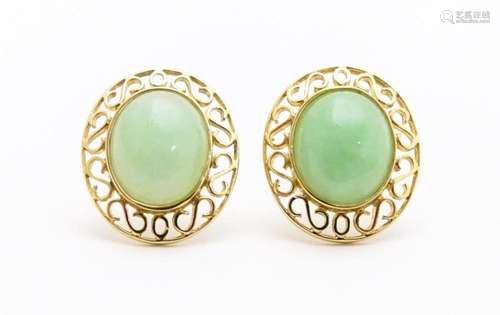 A pair of 9ct gold earrings set with jade coloured…