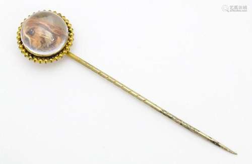 A gilt metal stick pin surmounted by an Essex Crys…