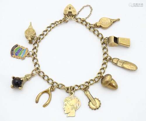 A 9ct gold and yellow metal charm bracelet set wit…