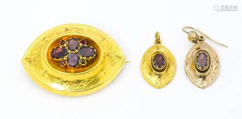 A 19thC yellow metal brooch set with central garne…