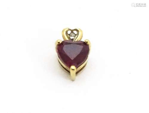 A yellow metal pendant set with ruby and diamond i…