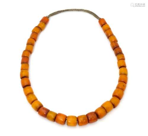 A vintage bead necklace of graduated amber coloure…