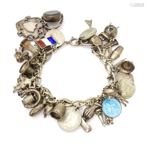 A silver charm bracelet set with a quantity of ass…