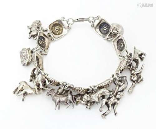 A white metal bracelet set with 13 white metal cha…