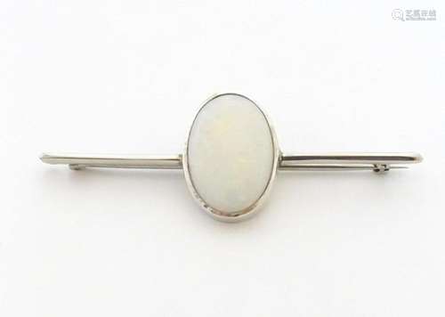 A 9ct white gold bar brooch set with central oval …