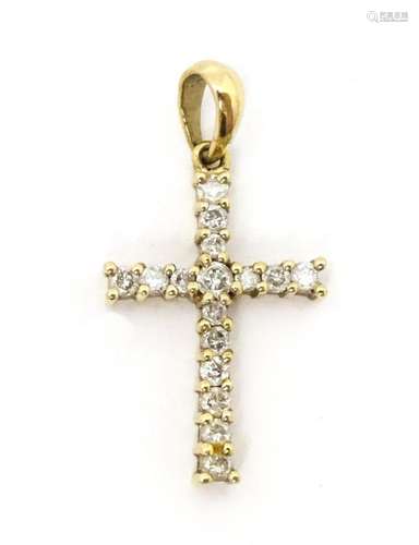 A 9ct gold cross form pendant set with diamonds. A…