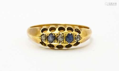 An 18ct gold ring set with sapphires and diamonds.…