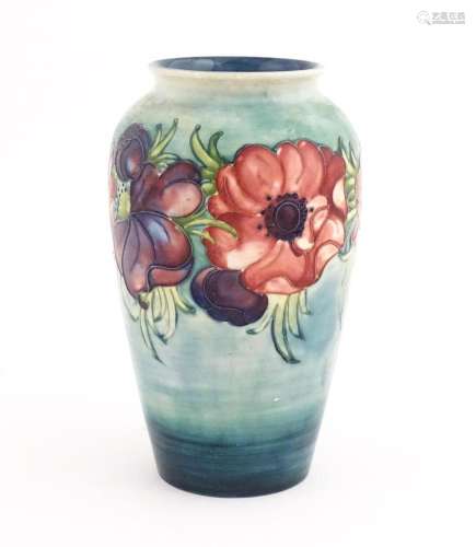 A Moorcroft vase decorated in the Anemone pattern.…