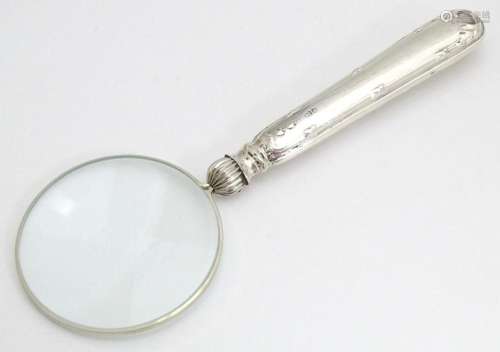 A silver handled magnifying glass. Approx. 5 1/2" …