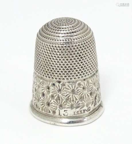 A silver thimble hallmarked Birmingham 1902. …