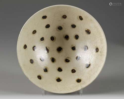 A CHINESE CREAM-GLAZED SPOTTED BOWL