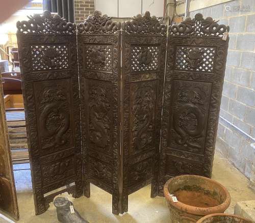 A Chinese carved hardwood four fold dressing screen, each pa...