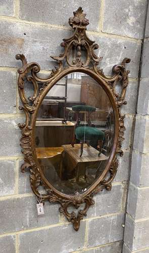 A Victorian style oval composition carved wall mirror, width...