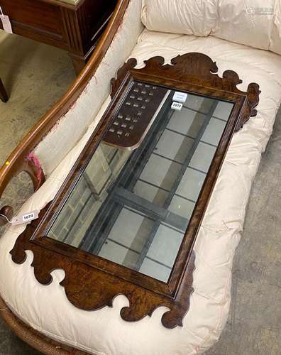 A reproduction 18th century style walnut fret-cut wall mirro...