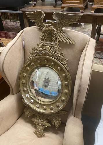 A Regency style giltwood and composition convex wall mirror,...