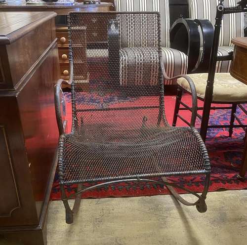 A vintage wrought iron and mesh garden rocking chair, width ...