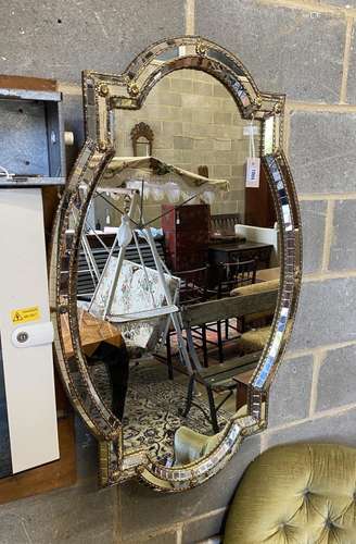 A Venetian style gilt metal oval wall mirror, width 71cm, he...