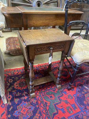 A Jacobean revival oak drop flap occasional table, width 41c...