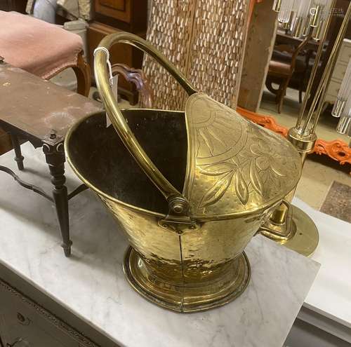 A 19th century Dutch embossed brass coal scuttle with swing ...