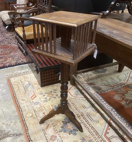 An early 20th century oak revolving bookstand on a tripod ba...