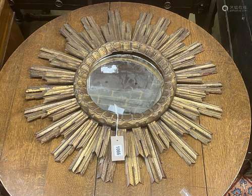 A vintage carved wood sunburst wall mirror, diameter 62cm