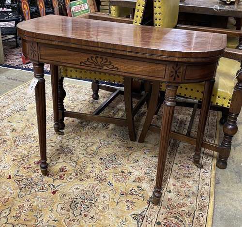 A Regency ebony inlaid mahogany D shaped folding card table,...