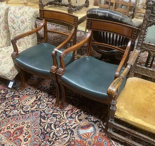 A pair of Regency style mahogany sabre leg elbow chairs, wid...