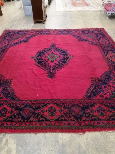 An Afghan red ground carpet, 330 x 314cm