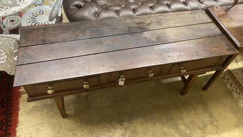 An 18th century oak low dresser on later square tapered legs...