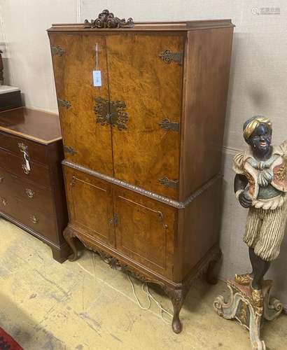 A Queen Anne revival brass mounted burr walnut cocktail cabi...