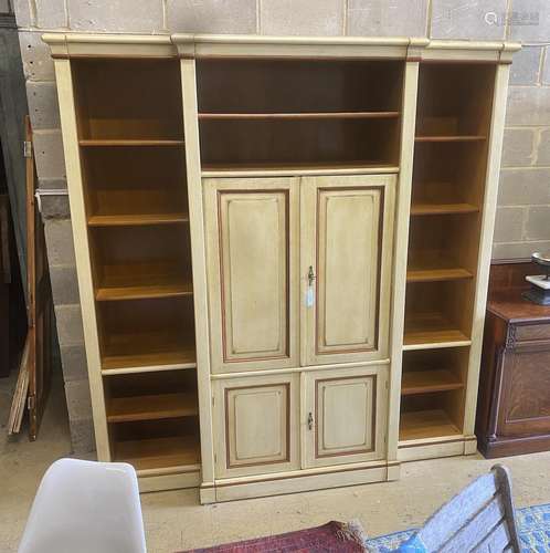 A reproduction Continental painted breakfront bookcase / med...