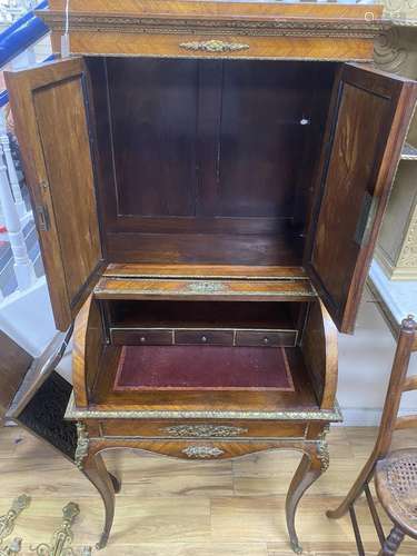 A French gilt metal mounted kingwood cylinder bureau cabinet...