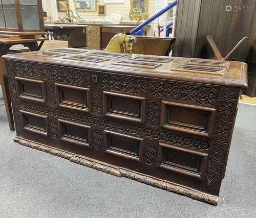 An 18th century carved panelled oak coffer, width 153cm, dep...